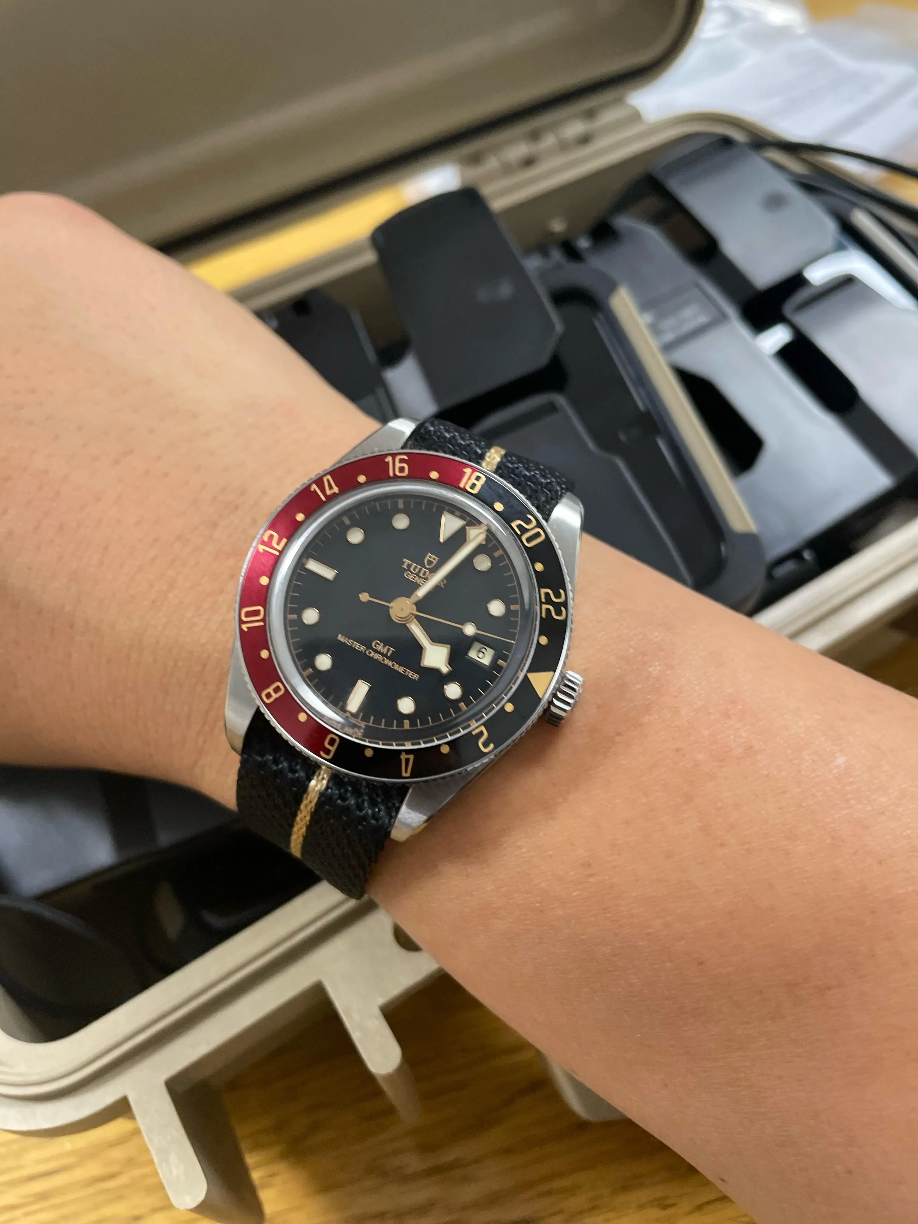 Tudor Black Bay 58 GMT on wrist, red-black bezel, black fabric strap