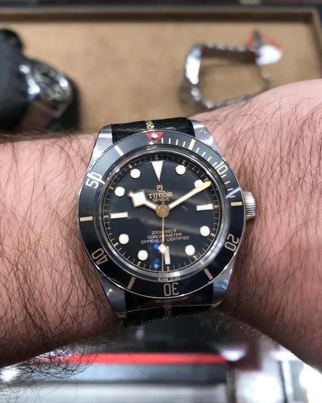 Tudor Black Bay 58 on wrist, black dial, gilt indices, black fabric strap