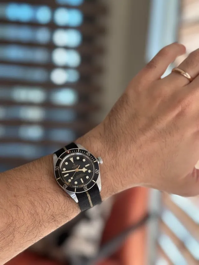 Tudor Black Bay 58 on wrist, black gilt dial, snowflake hands, fabric NATO strap