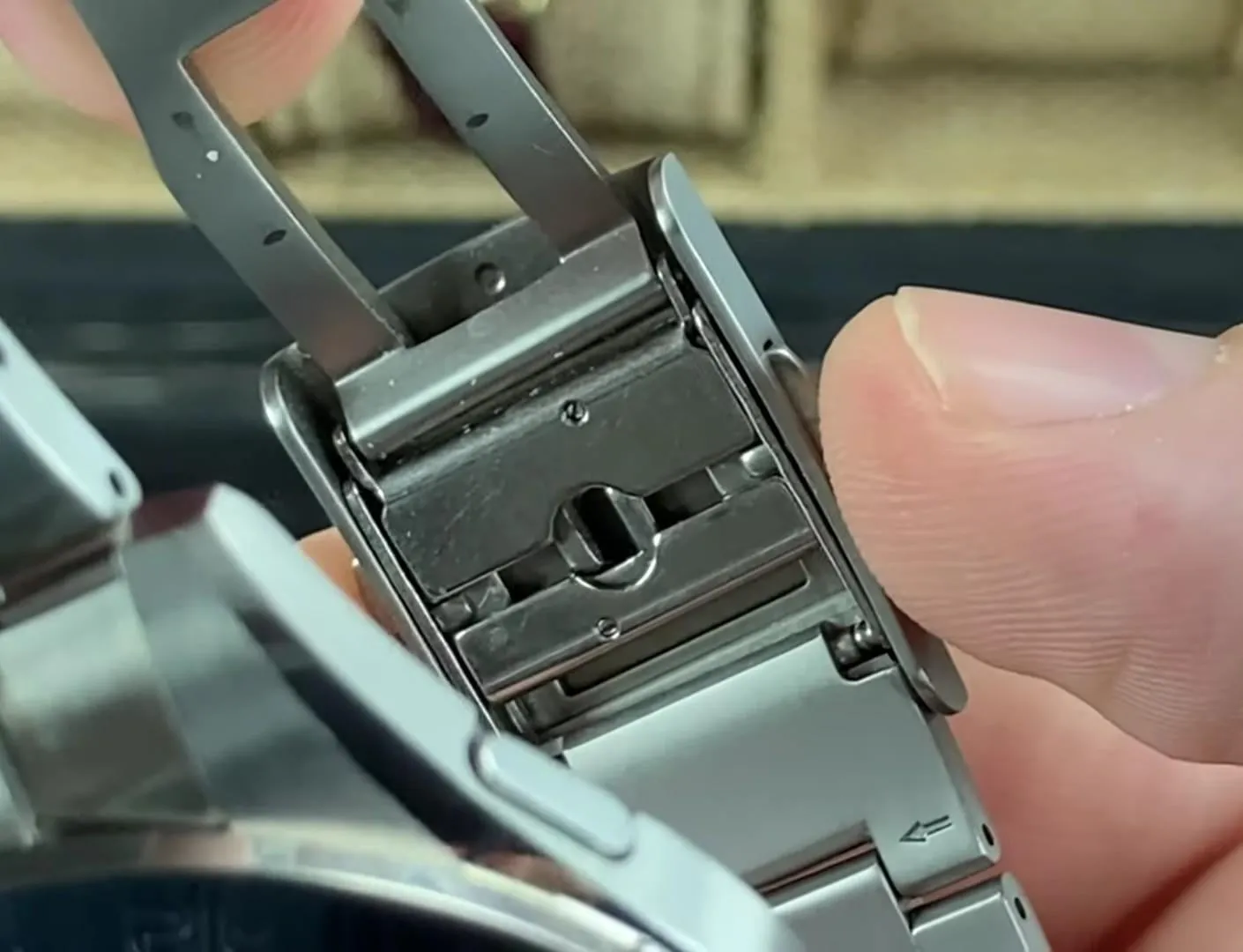 Macro of open deployant clasp interior showing sliding micro-adjustment mechanism and slots