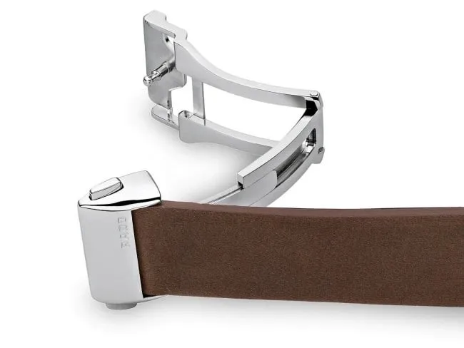 Open butterfly deployant clasp detached from brown leather strap on white background