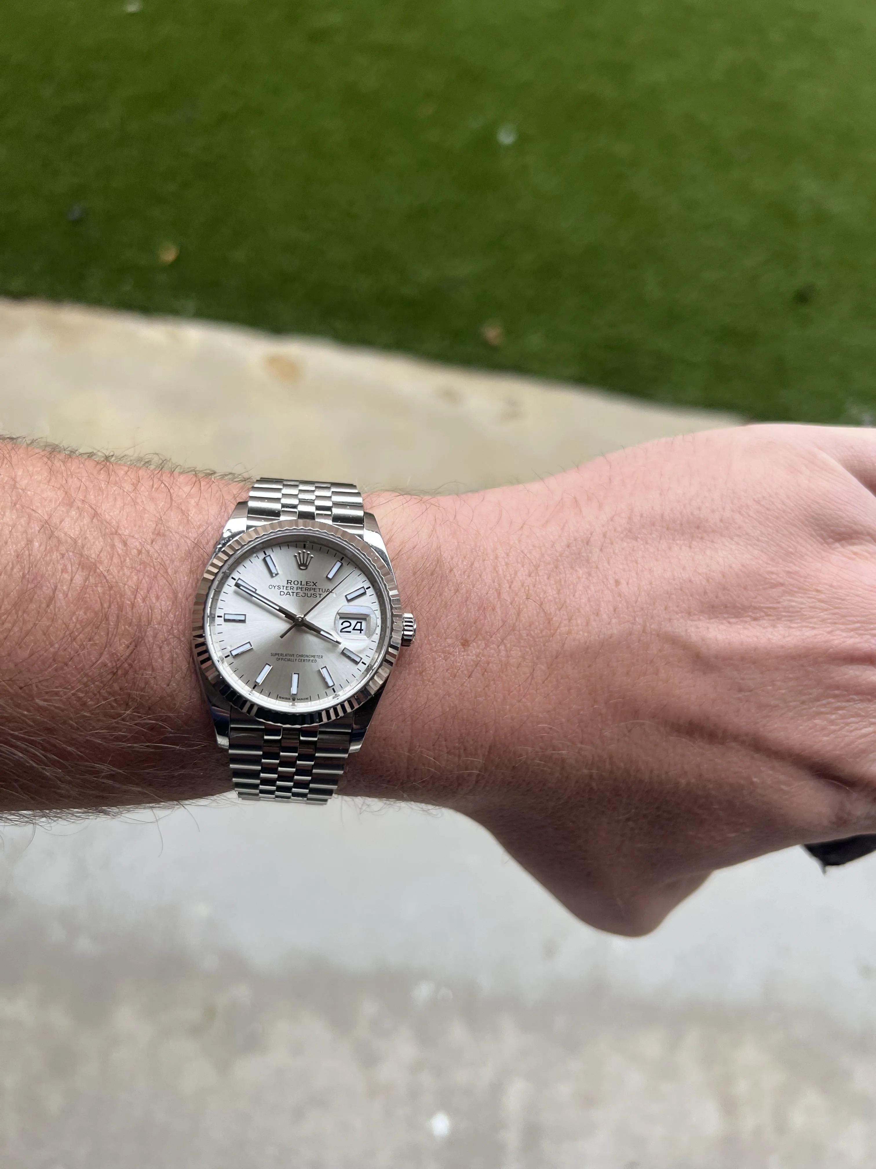 Rolex Datejust 36 silver dial fluted bezel Jubilee bracelet on wrist outdoors