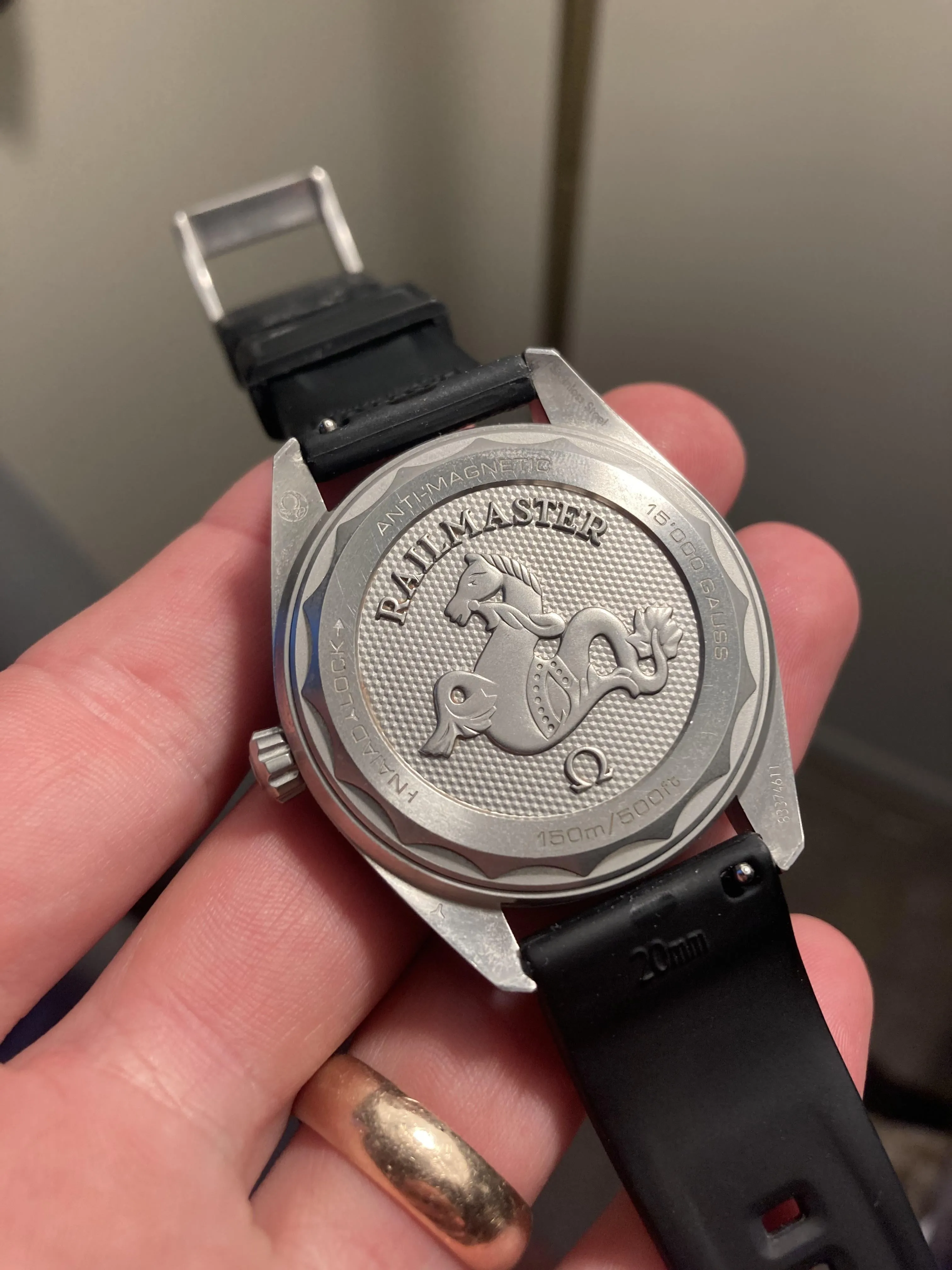 Omega Railmaster solid caseback with engraved hippocampus motif and text