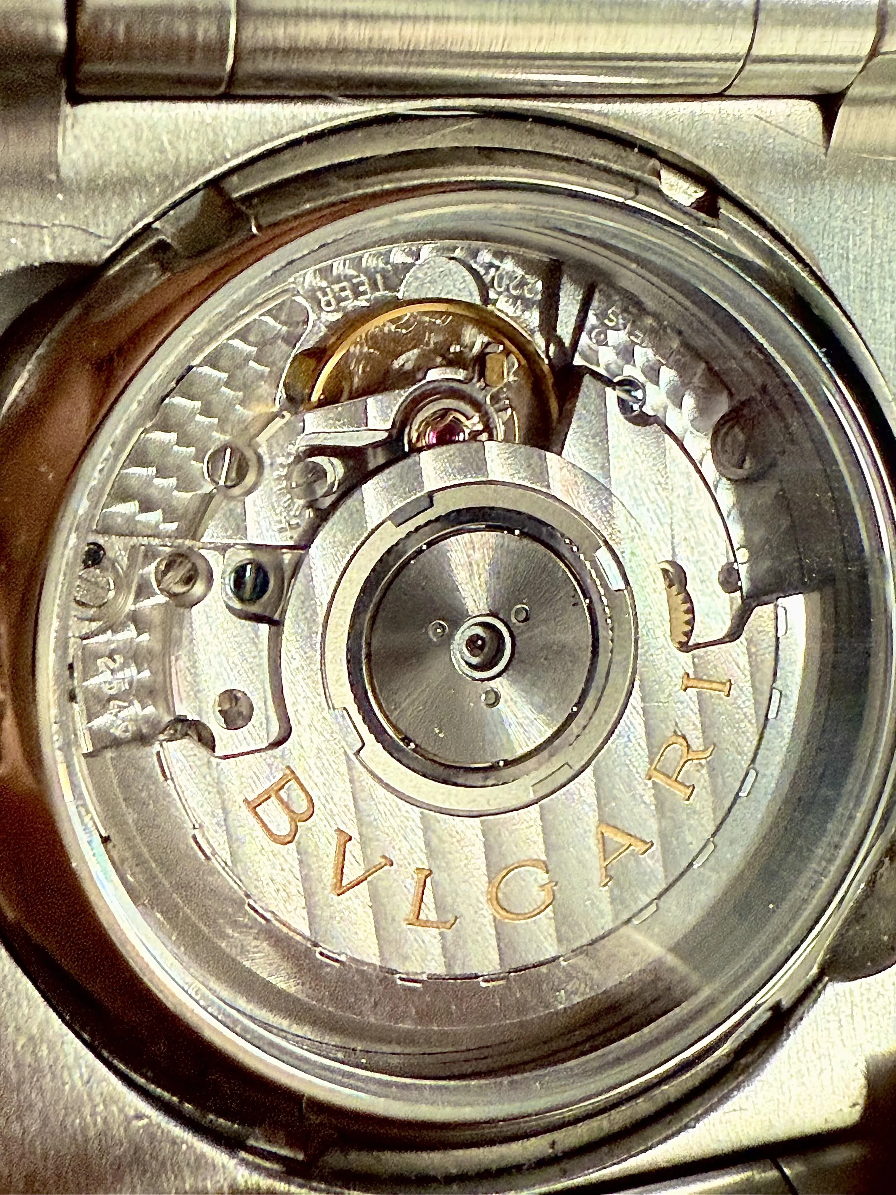 Bvlgari exhibition caseback showing striped movement plate and balance wheel