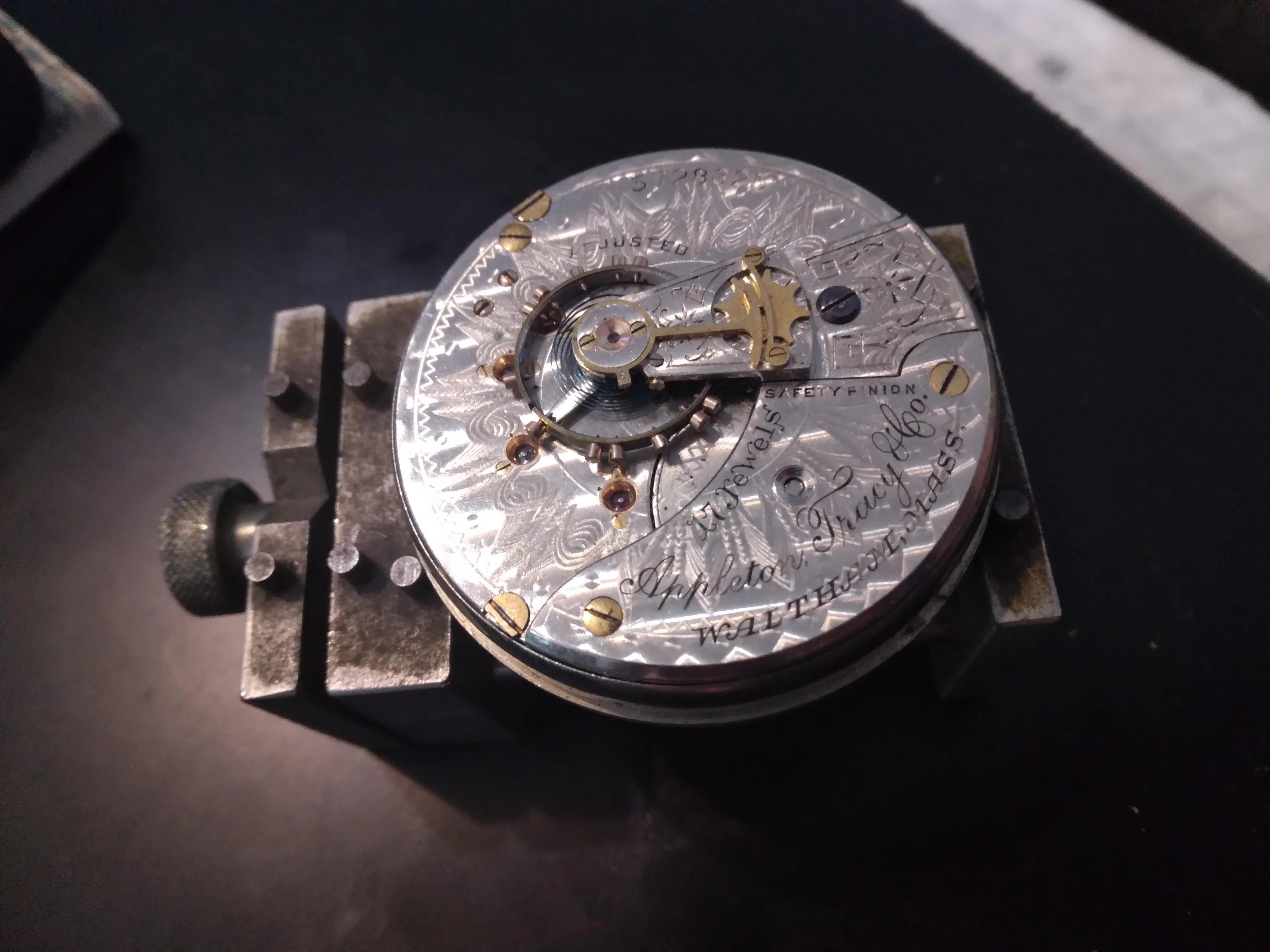 Waltham Appleton Tracy pocket watch movement in holder, engraved silver plate with gold regulator