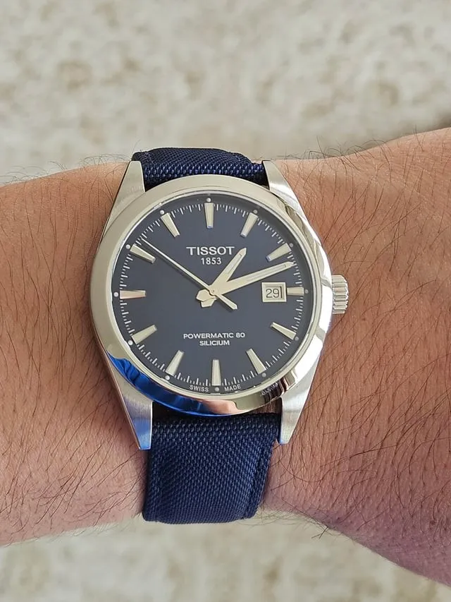 Tissot Gentleman Powermatic 80 blue dial on wrist with navy textile strap