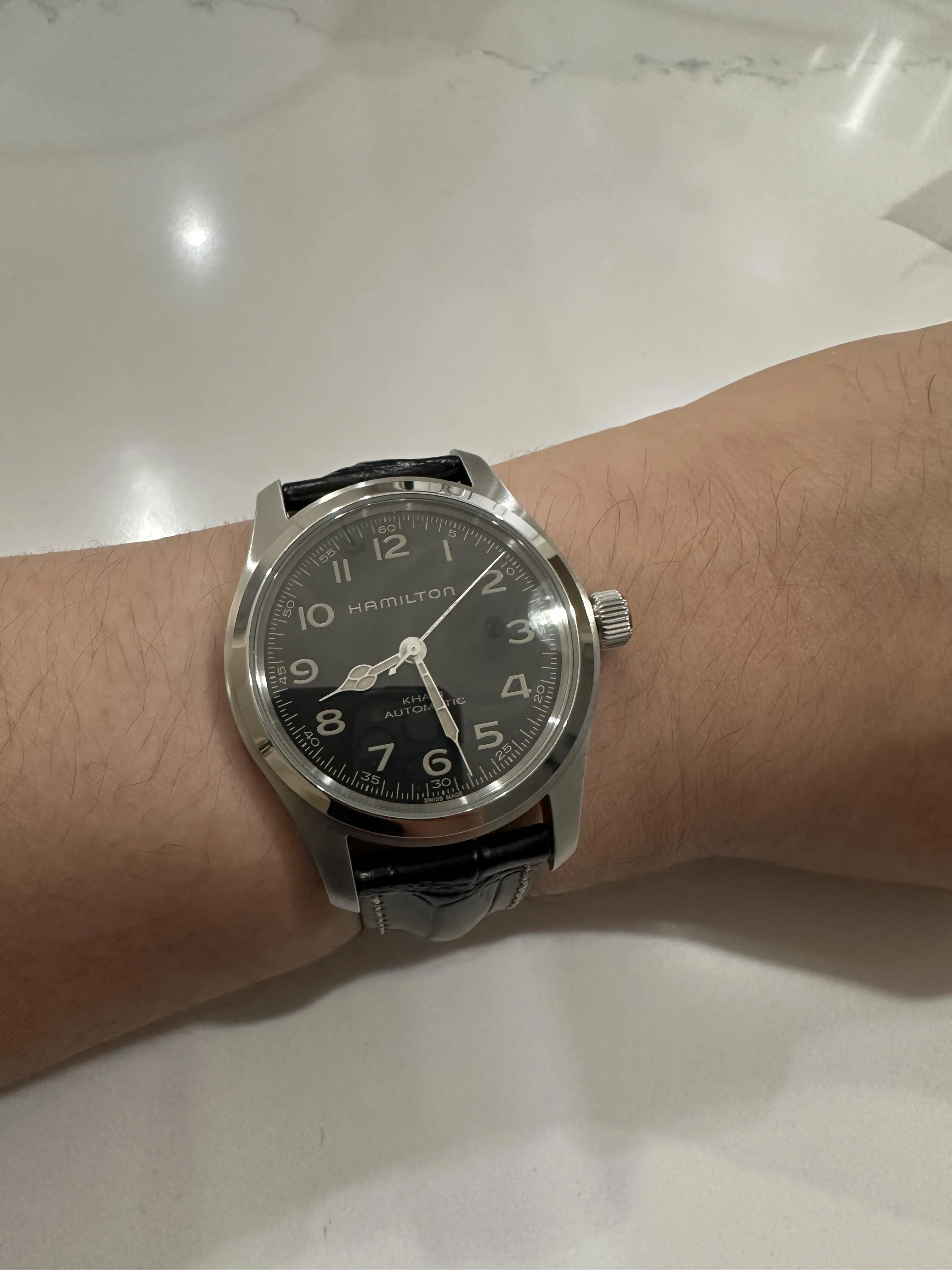 Hamilton Khaki Field Murph on wrist, bright light causing crystal glare on black dial
