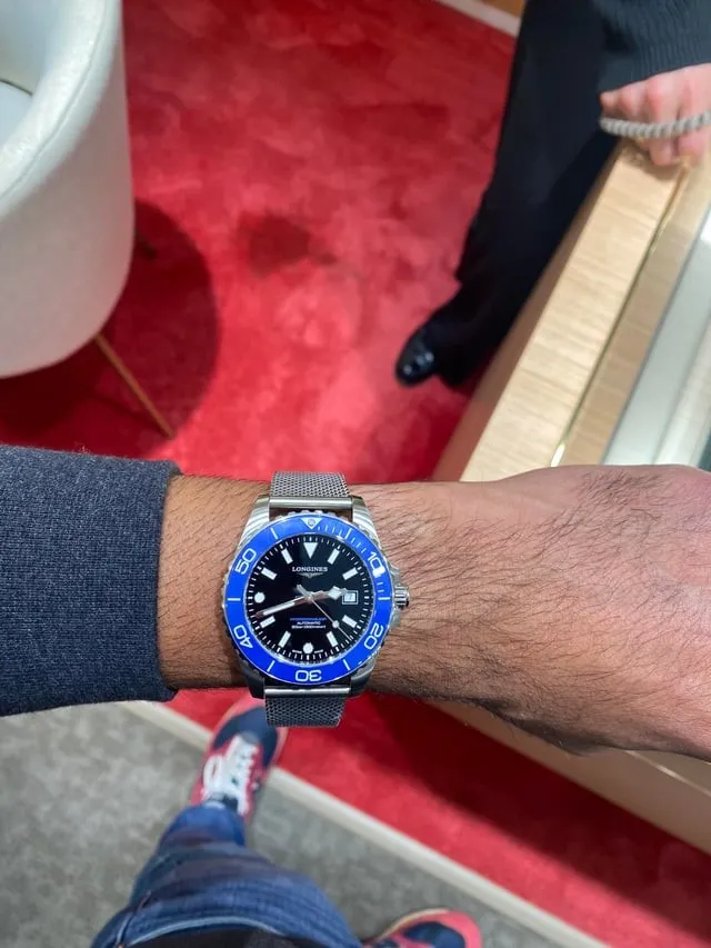 Longines HydroConquest black dial blue bezel on mesh bracelet, wrist shot