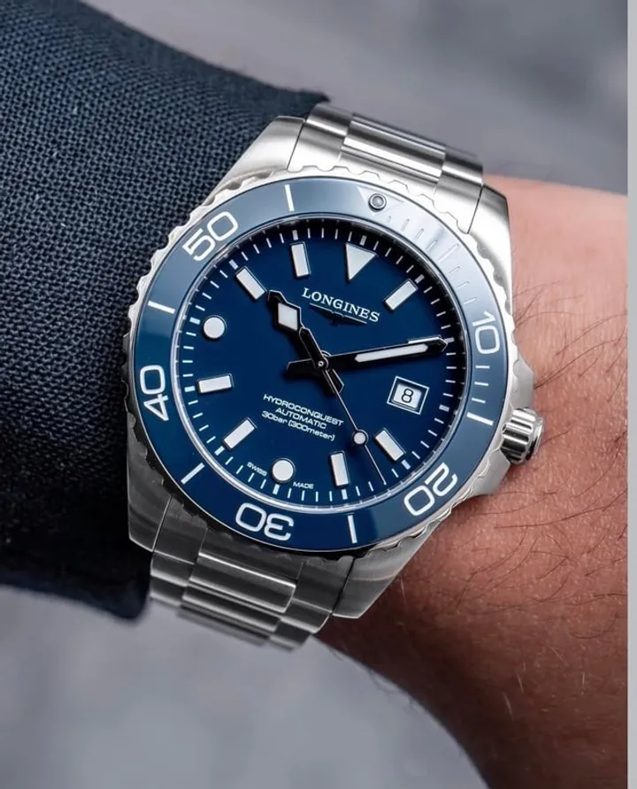 Longines HydroConquest blue dial blue bezel oyster bracelet, three-quarter wrist shot on jacket