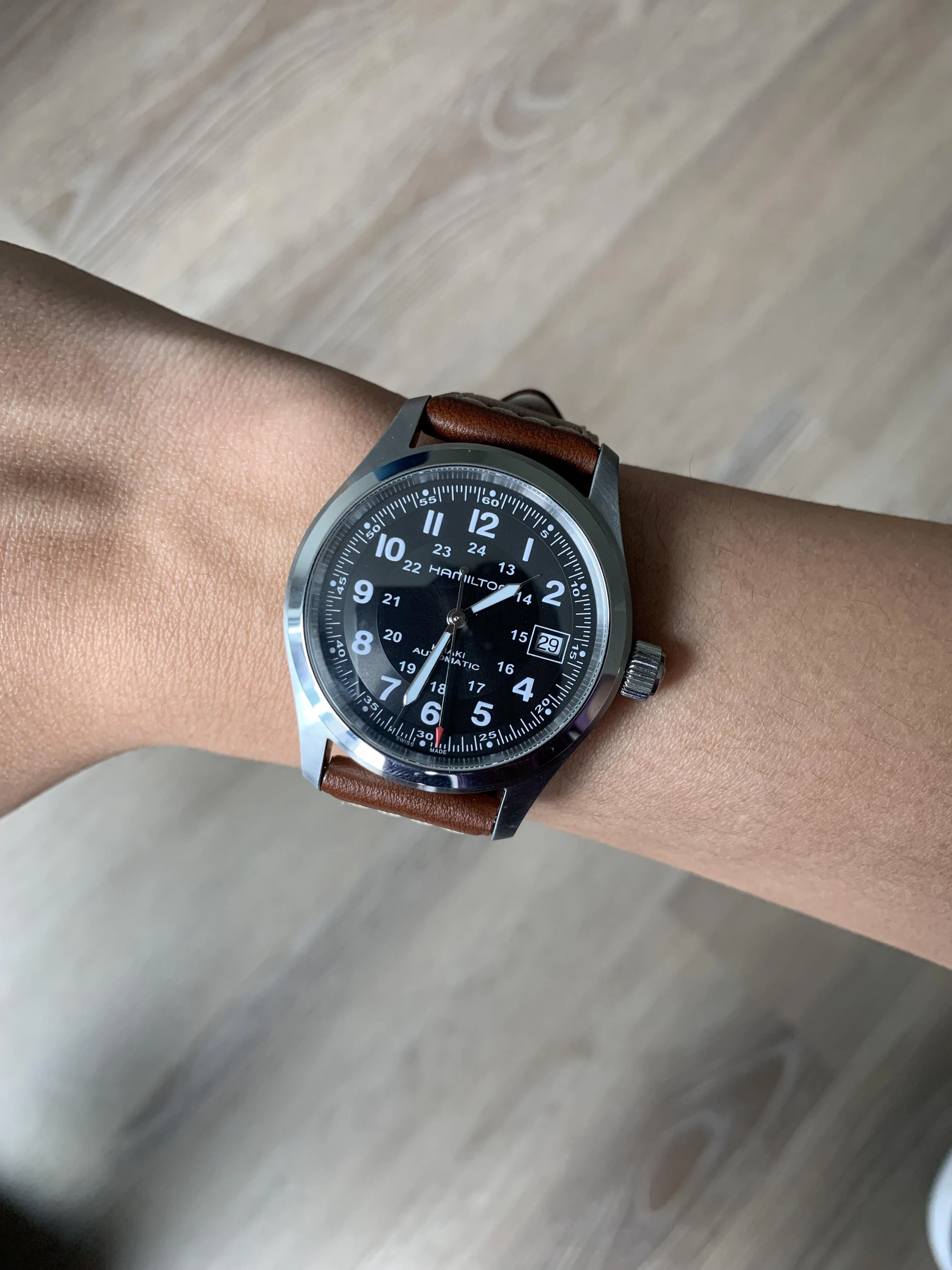 Hamilton Khaki Field on wrist, brown leather strap, lug tips partially visible