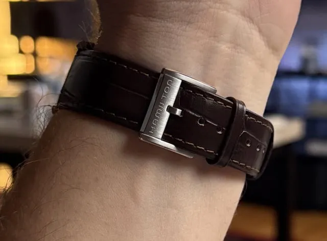 Hamilton pin buckle on brown leather strap, pin through hole, multiple holes visible