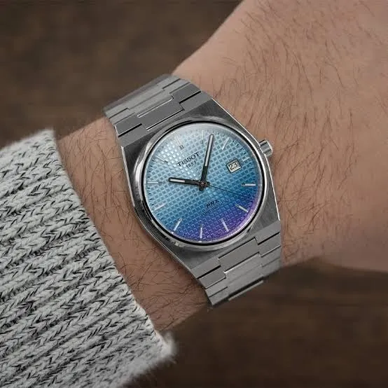 Tissot PRX ice-blue to purple gradient dial on wrist, colour shift visible
