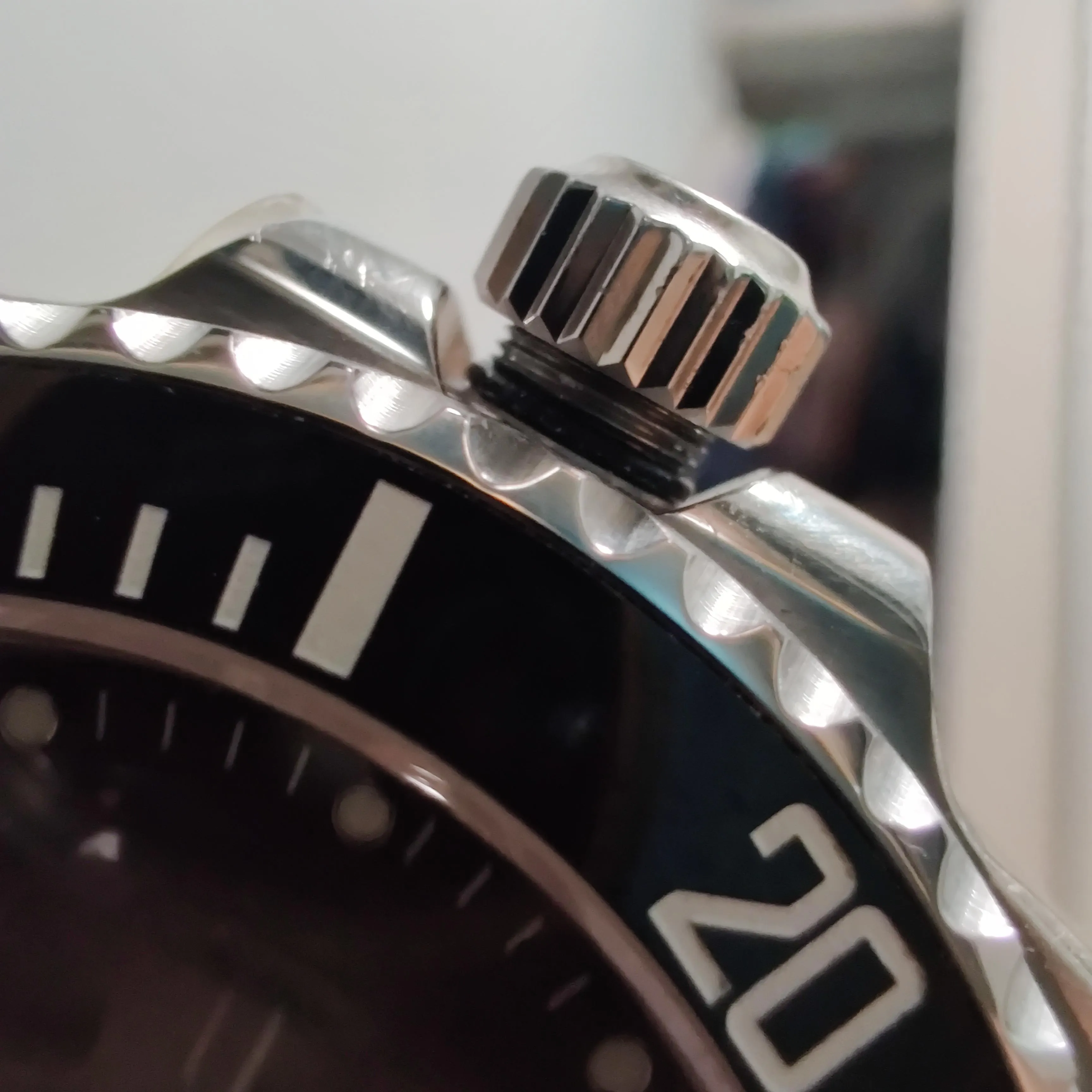 Macro of steel screw-down crown partially unscrewed showing threaded tube