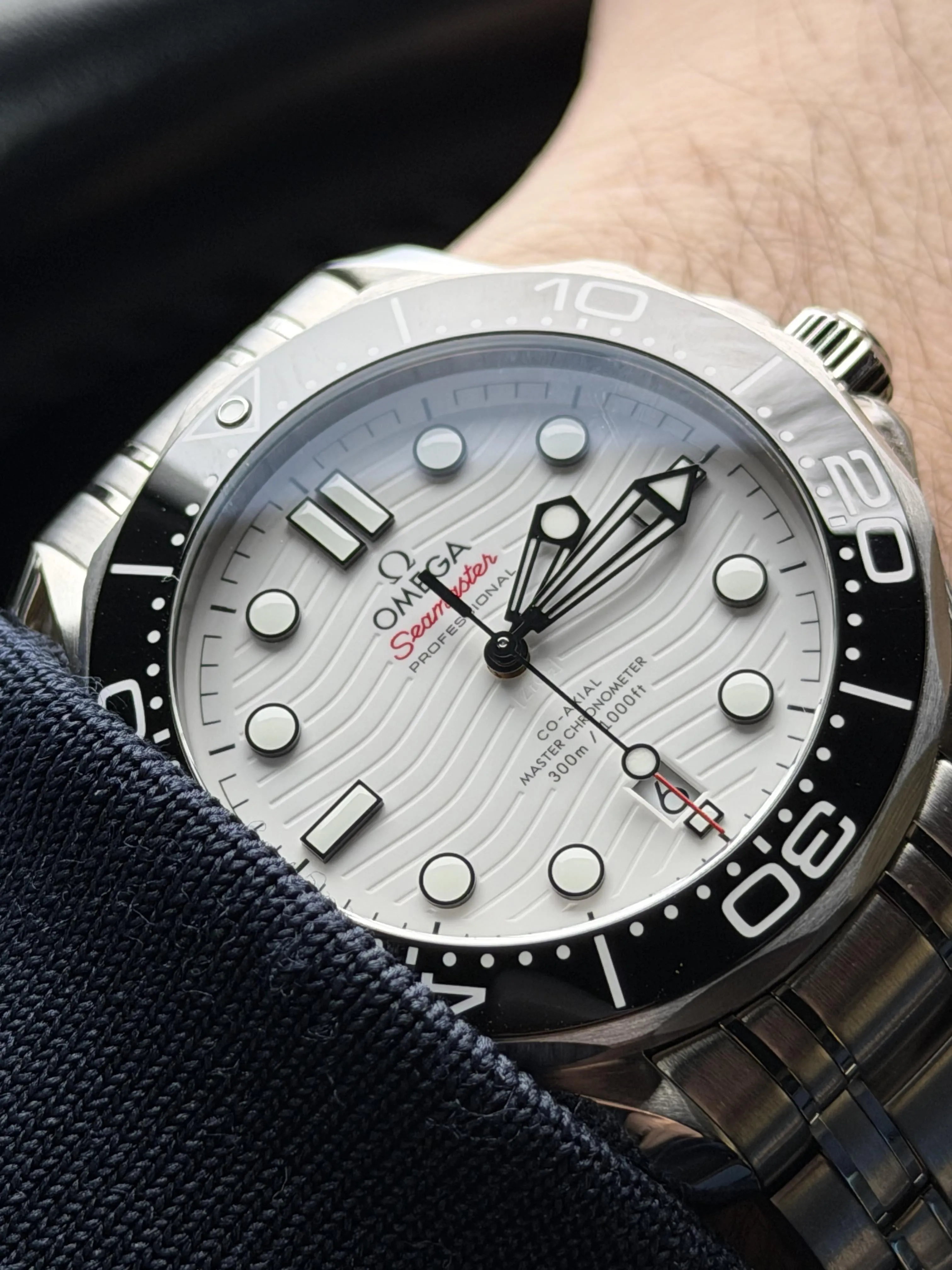 Omega Seamaster 300M white dial, black bezel, steel bracelet on wrist