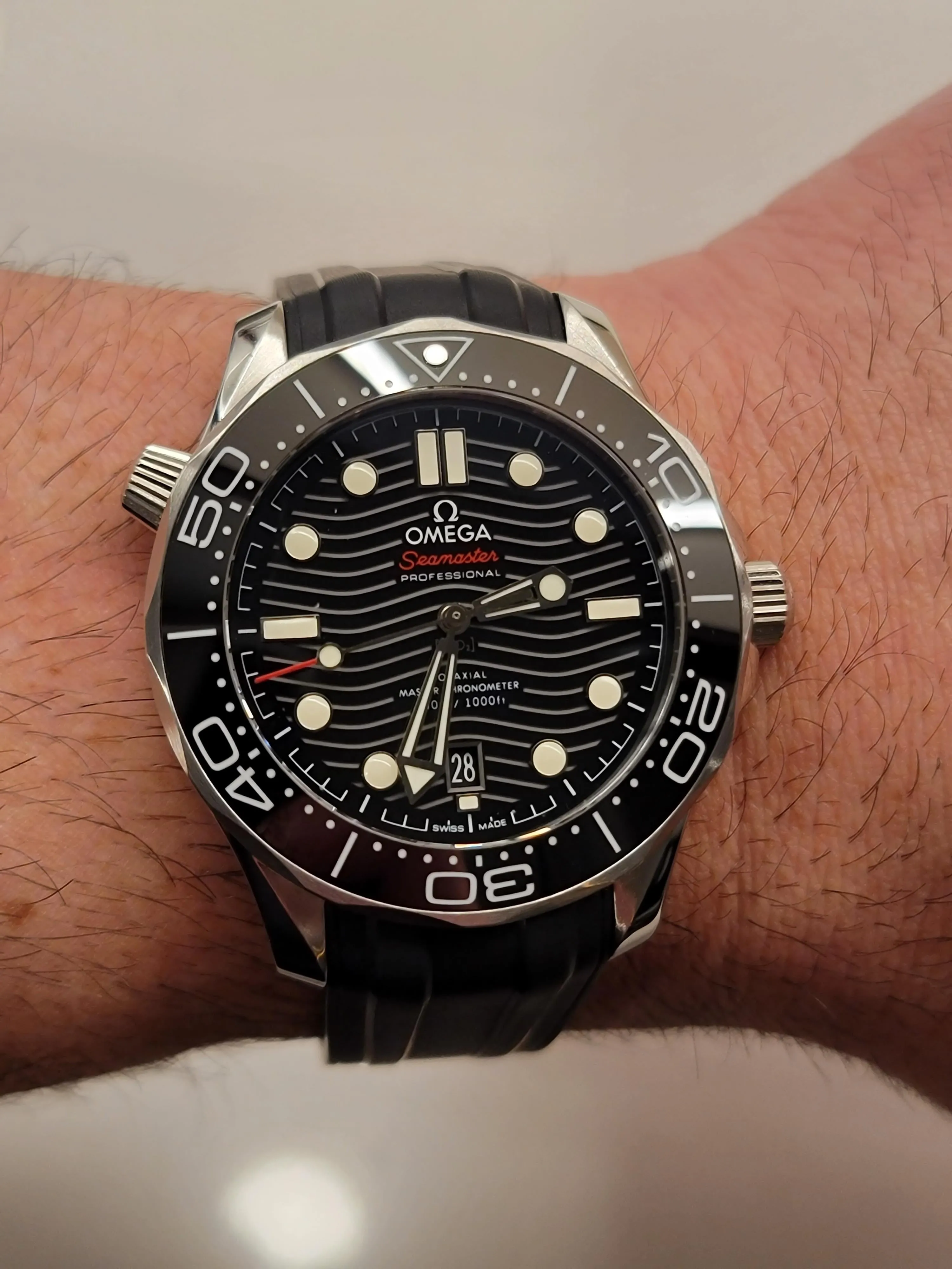 Omega Seamaster Diver 300M black wave dial, red Seamaster script, rubber strap, wrist shot