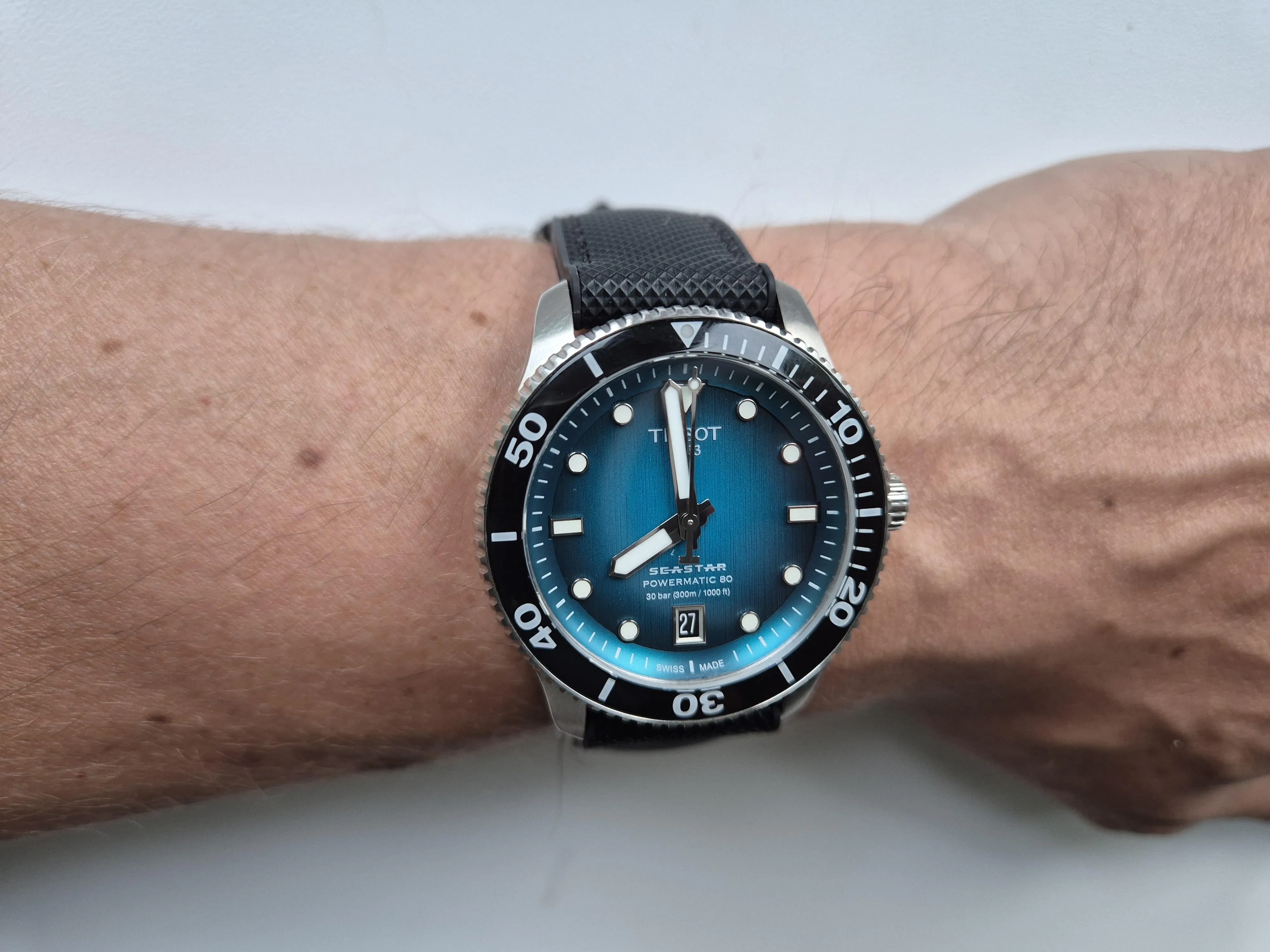 Tissot Seastar 1000 blue gradient dial on wrist, black bezel, rubber strap