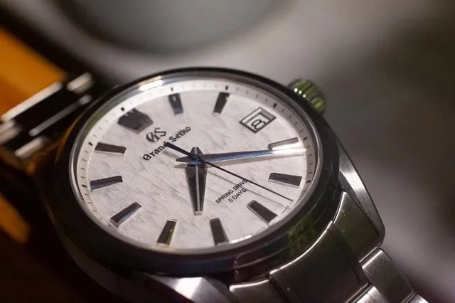 Grand Seiko SLGH005 white birch dial close-up on steel bracelet, table shot