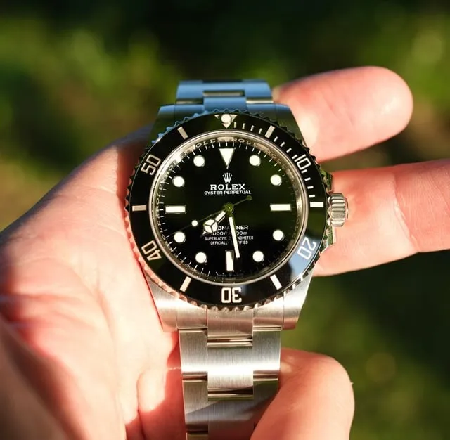 Modern Rolex Submariner 124060 no-date with black ceramic bezel held in fingers