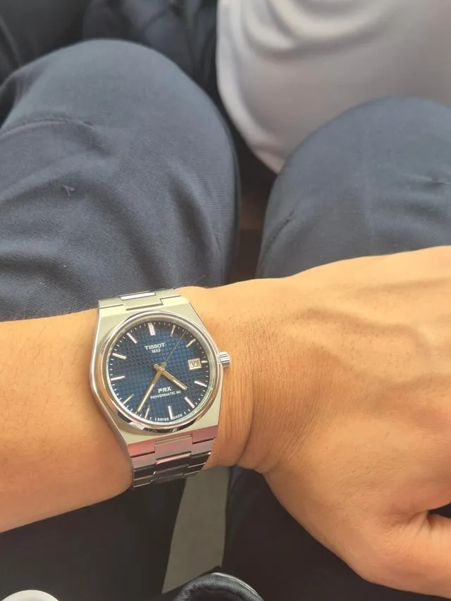 Tissot PRX Powermatic 80 blue dial on wrist, stainless bracelet