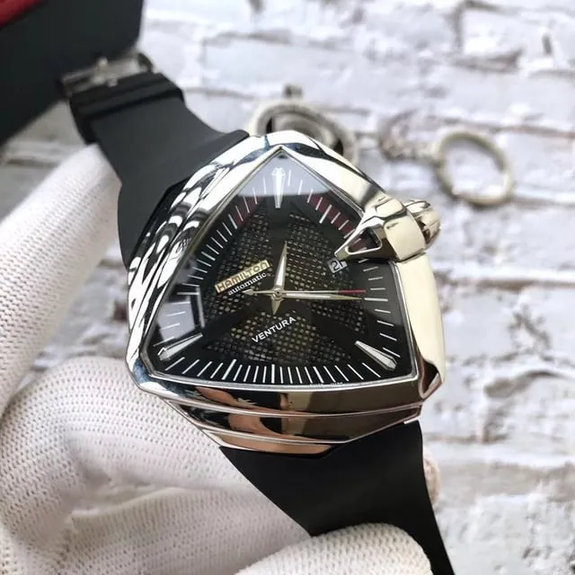 Hamilton Ventura black dial on rubber strap, three-quarter view in gloved hand